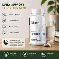 Olsiva Naturals Premium Brain Blend dietary supplement bottle shown on a tabletop with a glass of water, capsules, and a blurred plant in the background. Text highlights daily support for mind functions like memory, focus, concentration, and mental clarity.